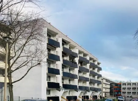 Wohnblock mit weißen Fassaden und Balkonkraftwerken im Stadtbereich